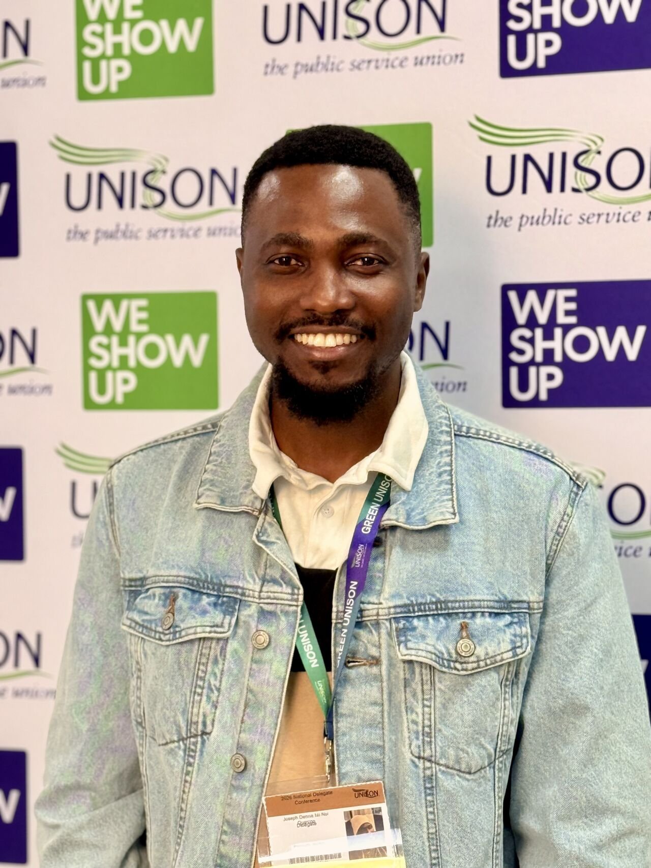 Joe Quarcoo standing in front of a UNISON conference backdrop.